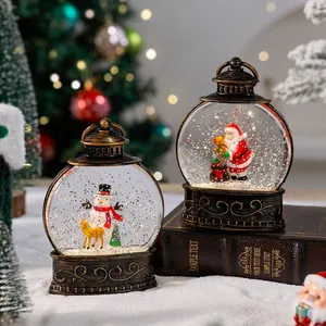 Vintage bronze Christmas water lantern with Santa and snowman figurines inside.