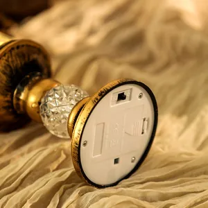 Close-up detail of Christmas crystal candle lamp base featuring switch and battery compartment