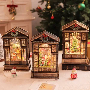 Detailed view of three vintage Christmas LED lanterns with swirling glitter snow scenes.