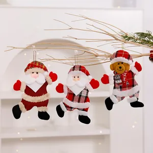 Detail of three plush Christmas hanging ornaments on a dry branch