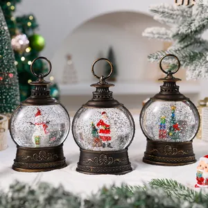 Trio of vintage Christmas snow globe lanterns featuring Santa, snowman, and tree details.