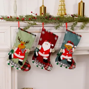 Detailed view of three linen Christmas stockings with 3D reindeer, Santa, and bear appliques.