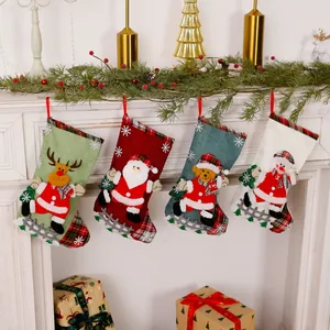 Set of four festive linen Christmas stockings hanging on a white fireplace mantel.