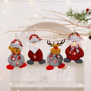 Detailed view of four Christmas fabric ornaments hanging on a decorative branch
