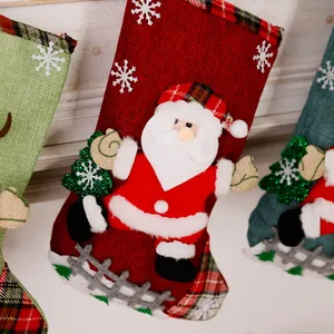 Close-up of a festive red burlap Christmas stocking with Santa Claus applique.