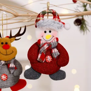Close-up of a festive plush snowman Christmas tree hanging ornament with a red burlap body