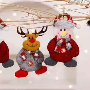 Detailed view of handmade reindeer and snowman fabric ornaments for Christmas tree decor