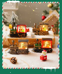 Set of four illuminated Christmas snow globe trains with Santa Claus and snowman