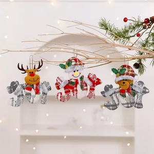 Close-up of JOY plush Christmas ornaments with reindeer, snowman, and bear characters