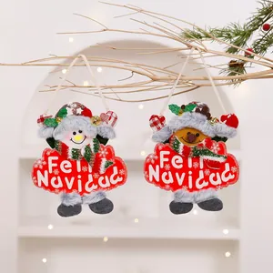 Close-up of festive plush Christmas dolls with Feliz Navidad signs
