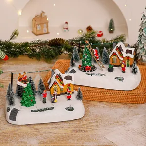 Zwei europäische Weihnachtsdorf-Spieluhr-Ornamente mit leuchtenden Lichtern und Nikolaus.