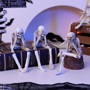 Set of three resin skeletons in See, Hear, Speak No Evil poses with hanging legs