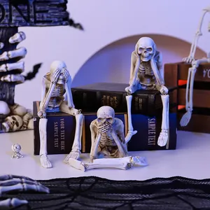 Detail view of Halloween skeleton trio figurines in see-hear-speak no evil poses.