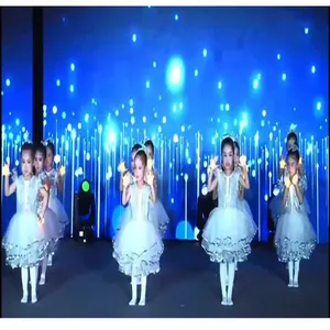 Close-up of children holding glowing star prop lights during stage performance