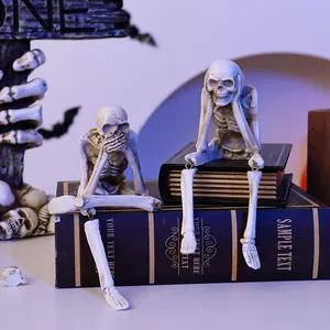 Macro view of Halloween resin skeleton figurines sitting on vintage books