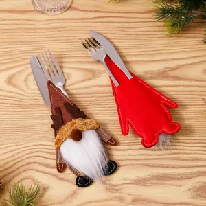 Detailopname van kerstkabouter bestekhouders met rendierontwerp op houten tafel.