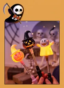 Close-up of Halloween glowing wands featuring pumpkin and ghost designs in festive setting