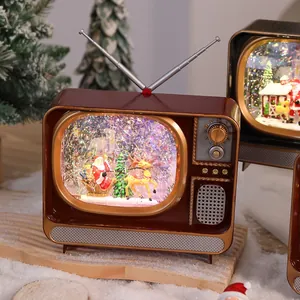 Detail of a retro TV-shaped Christmas music box with Santa Claus and snowing glitter effects.