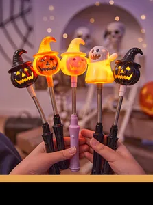 Detailed view of five colorful glowing Halloween pumpkin and ghost wands for kids party.