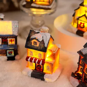 Detailed macro view of a miniature glowing Christmas resin house with artificial snow