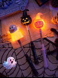 Close-up of glowing Halloween wands featuring ghost and pumpkin designs for party decor.