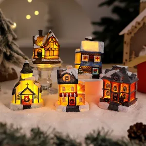 Detailed view of illuminated miniature Christmas village houses with snowy textures