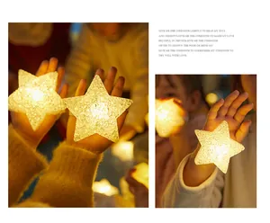 Close-up of glowing warm yellow star-shaped LED handheld lights for kids' performances