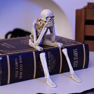 Close-up of a resin skeleton figurine with dangling legs for Halloween decor.