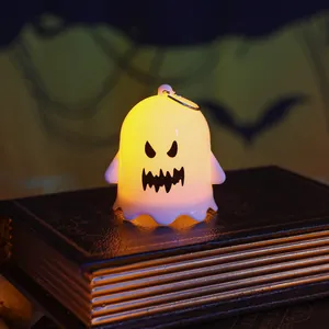 Adorable glowing Halloween ghost night light sitting on a vintage decorative book prop