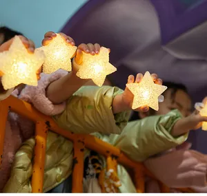 Handheld glowing star wrist lights for children's dance performance and festive decor.