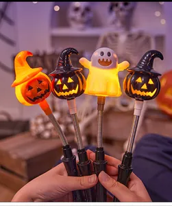 Close-up shot of glowing Halloween hand-held sticks featuring pumpkin and ghost designs.