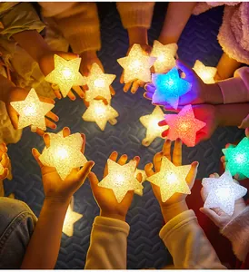 Children holding colorful glowing LED star lights for festival performance atmosphere