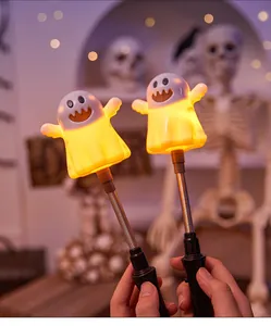 Close-up of cute glowing ghost hand sticks with spring neck for Halloween party decor