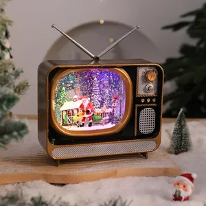 Close-up of vintage Christmas TV music box with Santa Claus and glowing snow scene decoration
