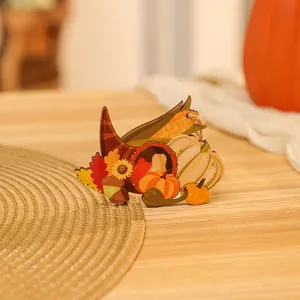 Detailed view of hand-painted wooden Thanksgiving pendant with pumpkin and cornucopia