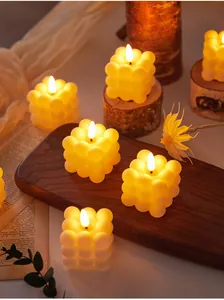 Warm yellow bubble LED candles on rustic wooden board for romantic ambient lighting