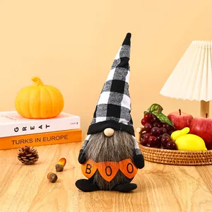 Detail of Halloween gnome faceless doll holding a BOO banner in a cozy festive scene