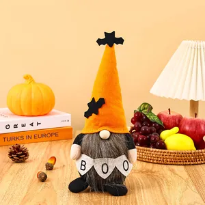 Detail of a Halloween gnome plush doll holding a BOO banner in a cozy home setting.