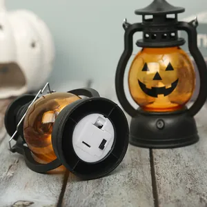 Detail view of Halloween pumpkin lantern base showing battery compartment and switch.
