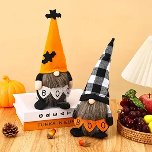 Close-up of Halloween gnomes holding BOO banners in a cozy festive autumn setting