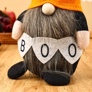 Detailed macro view of a Halloween faceless gnome doll holding a Boo banner.