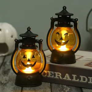 Detail of Halloween pumpkin lanterns with glowing warm yellow light on a dark background