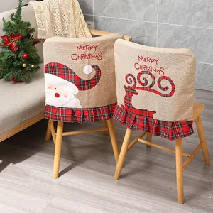 Detail of Christmas linen chair covers with embroidered Santa and reindeer patterns