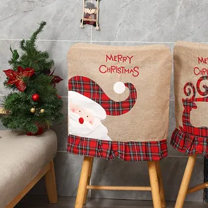 Detailed view of linen Christmas chair cover with Santa Claus embroidery and red plaid