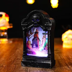Detailed close-up of a glowing Halloween tombstone night light with spooky internal scene