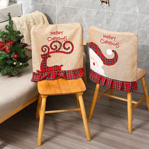 Detailed view of embroidered Christmas burlap chair covers with elk and Santa motifs.