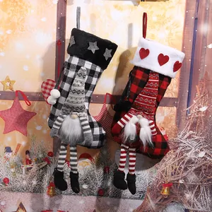 Red and black plaid Christmas stockings with gnome figures and heart star details
