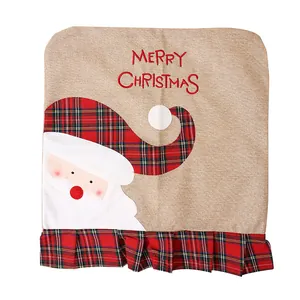 Detail of Christmas burlap chair cover featuring Santa Claus embroidery and plaid accents.