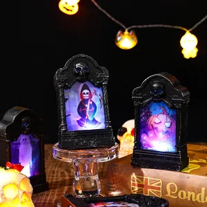 Detailed view of Halloween LED tombstone lights with spooky pumpkin and reaper graphics