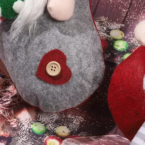 Detailed close-up of a handmade Christmas gnome stocking with felt heart and wooden button